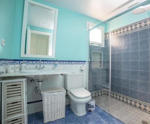 a bathroom with a toilet and a sink and a shower at Lightbooking Oasis Royal Corralejo in Corralejo