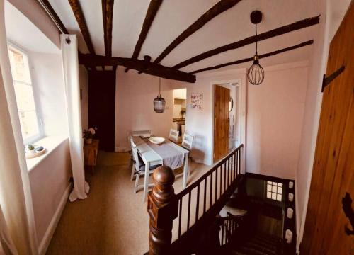 a room with a table and a dining room at Hideaway Cottage Sleaford in Sleaford