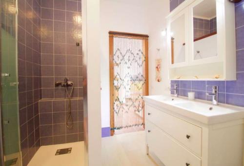 a bathroom with a sink and a shower at Lightbooking La Graciosa in Caleta de Sebo