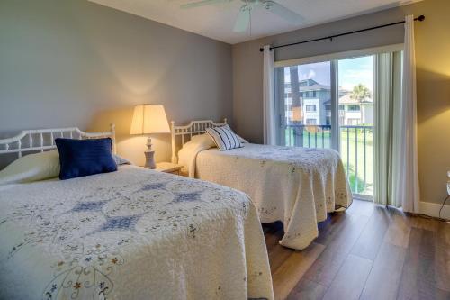 a bedroom with two beds and a sliding glass door at Sunny Ocean Village Condo with Community Pool! in Fort Pierce