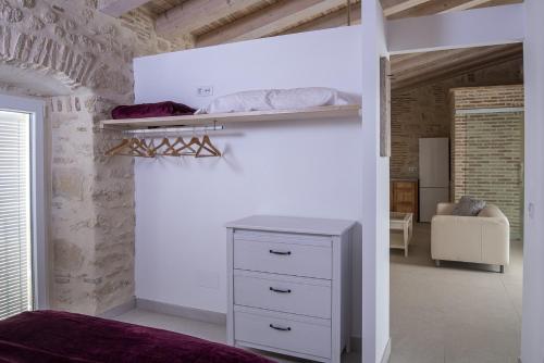 a bedroom with a bed and a white wall at Casa Palacio De La Cruz in El Puerto de Santa María