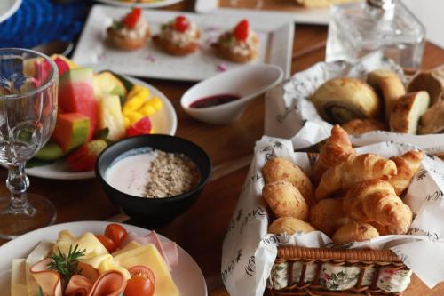 a table topped with plates of food and fruit at Pousada Rangai in Maragogi