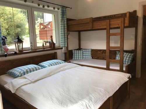 a bedroom with two bunk beds and a window at Horský apartmán Vrátna-Saška in Terchová