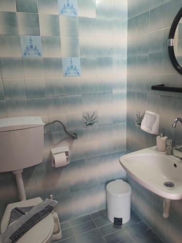 a bathroom with a toilet and a sink at Paradise in Kefalos