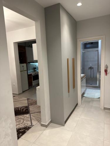 a room with a hallway with a sink and a bathroom at A&A Apartment in Piraeus