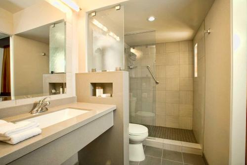 a bathroom with a sink and a toilet and a shower at Gold Coast Casino by the Strip Las Vegas in Las Vegas