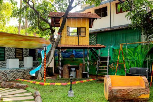 a tree house in a yard with a playground at Belljem Homes -your own private resort -3 BHK FF in Trichūr