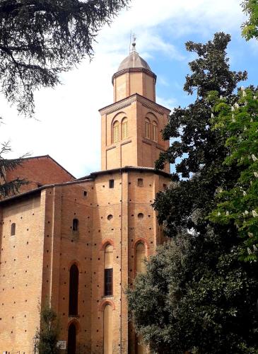 a large brick building with a tower on top of it at La casa del Vescovo in Imola