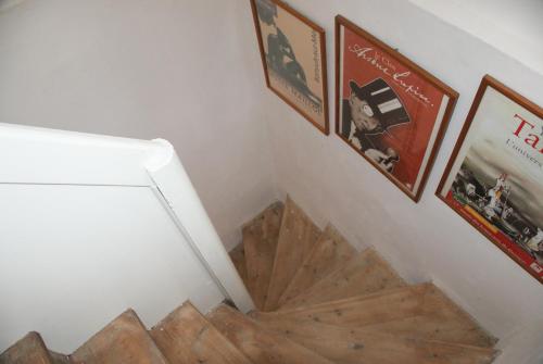 a stairwell with pictures and pictures on the wall at La Vigie in Couëron
