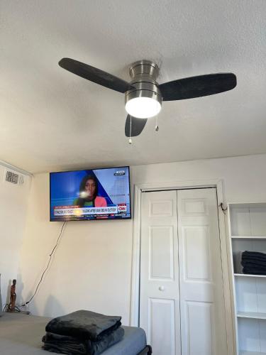 a ceiling fan in a bedroom with a tv on the wall at Best Value inside City Miami, Near Airport, Beach, Center & Metro in Miami