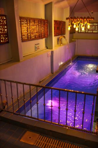 a swimming pool with purple lighting in a building at Belljem Homes -your own private resort -3 BHK FF in Trichūr