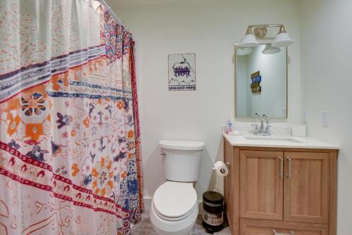 a bathroom with a toilet and a sink and a shower curtain at North Conway Townhome with Private Hot Tub and Deck! in North Conway