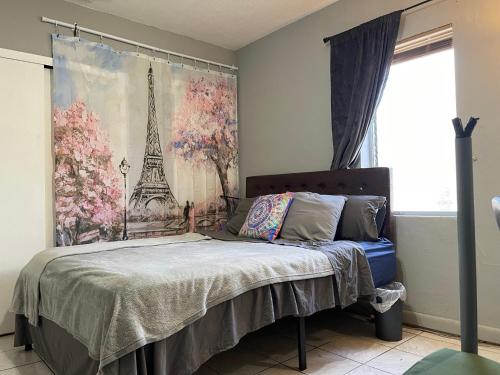 a bedroom with a bed and a picture of the eiffel tower at Best Value inside City Miami, Near Airport, Beach, Center & Metro in Miami