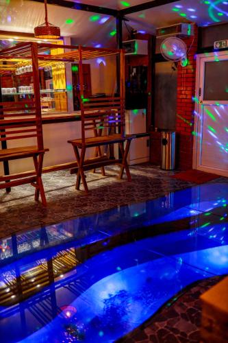 a pool in a bar with two chairs and a table at Belljem Homes -your own private resort -3 BHK FF in Trichūr