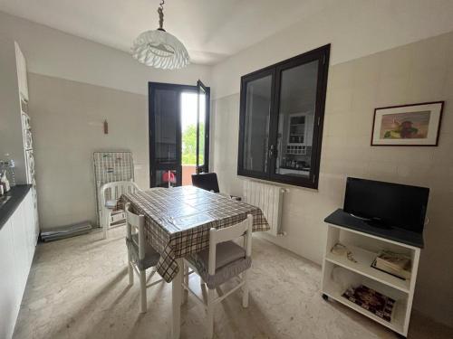 a dining room with a table and a television at Casa A&G in Marsala