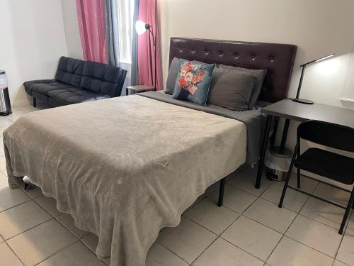 a bedroom with a large bed and a couch at Best Value inside City Miami, Near Airport, Beach, Center & Metro in Miami