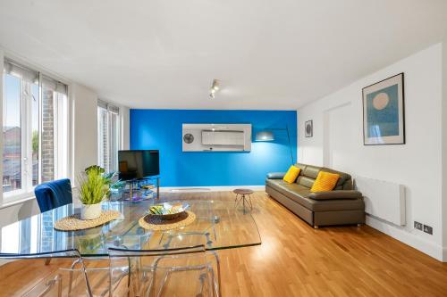 a living room with a glass table and a couch at Mulberry Flat 5 - One bedroom 3rd floor by City Living London in London