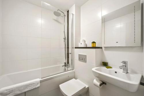 a white bathroom with a sink and a toilet at Mulberry Flat 5 - One bedroom 3rd floor by City Living London in London