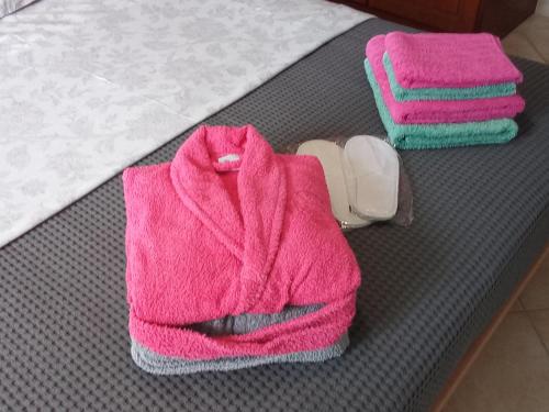 a pair of pink towels and a pair of socks at Xenia's Apartments in Alepou in Corfu