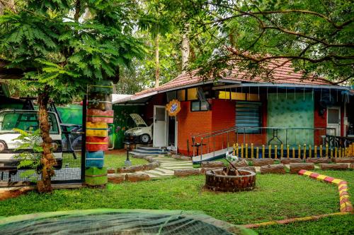 a small house with a tree in front of it at Belljem Homes -your own private resort -4 BHK FF in Trichūr