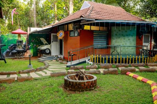 a small red house with a playground in front of it at Belljem Homes -your own private resort -4 BHK FF in Trichūr