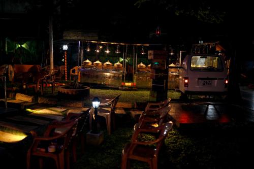 a food truck at night with chairs and lights at Belljem Homes -your own private resort -4 BHK FF in Trichūr