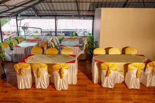 a group of tables and chairs with yellow bows at Belljem Homes -your own private resort -4 BHK FF in Trichūr
