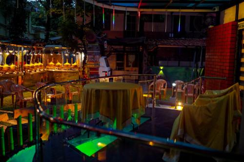 a room with a table and chairs and lights at Belljem Homes -your own private resort -4 BHK FF in Trichūr