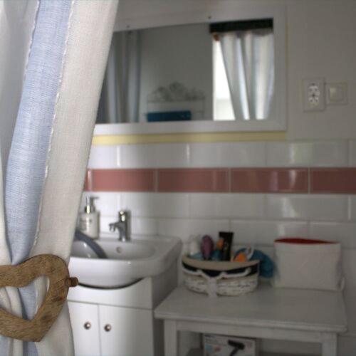 a small bathroom with a sink and a mirror at Villa Délibáb in Badacsonytomaj