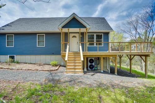 a blue house with a porch and a deck at Sleepy Hollow Lake Home with Deck, Pool Access! in Athens