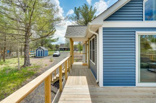 a blue house with a wooden ramp leading to a porch at Sleepy Hollow Lake Home with Deck, Pool Access! in Athens