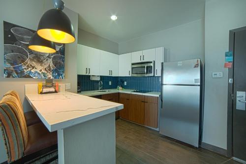 a kitchen with a refrigerator and a counter top at Staybridge Suites Houston-NASA Clear Lake by IHG in Webster
