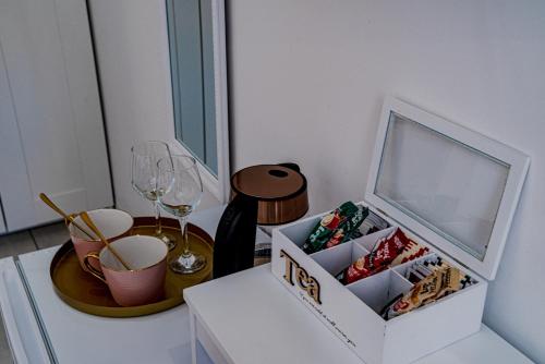 a table with a box of chocolates and wine glasses at Korkyra Central Rooms in Korčula