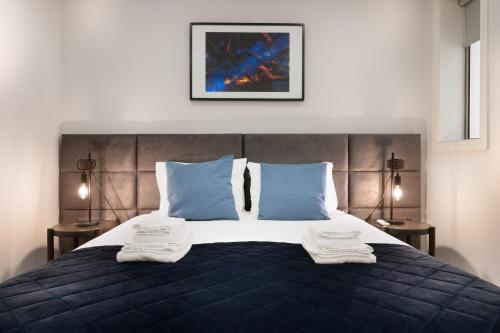 a bedroom with a bed with two towels on it at Invicta Premium - Downtown apartment in Porto