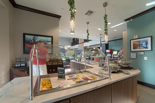 a restaurant with a buffet line with food on display at Staybridge Suites Houston-NASA Clear Lake by IHG in Webster