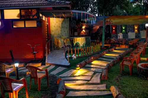 a patio with chairs and tables and a building at Belljem Homes -your own private resort -4 BHK FF in Trichūr