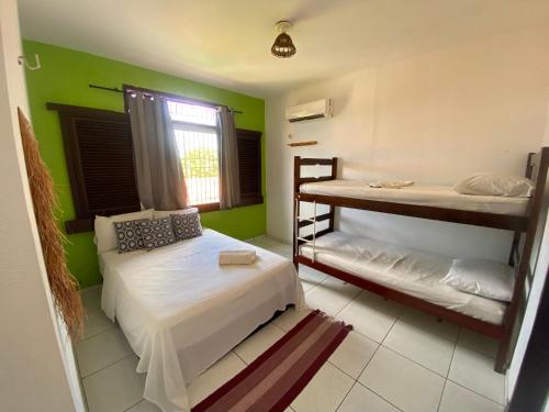 a bedroom with two bunk beds and a window at Parnaíba Hostel in Parnaíba