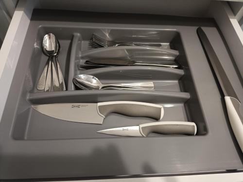 a drawer filled with silver utensils and a knife at Apartment COMFORT on Ruska street in Chernivtsi