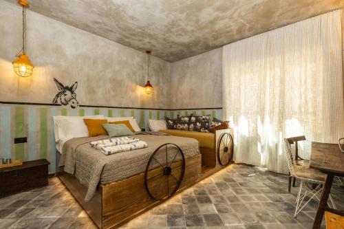 a bedroom with a large bed in a room at Via Roma Charming Rooms in Baunei