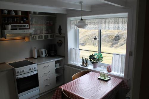 a kitchen with a table and a window at Cottage in Saksun in Saksun