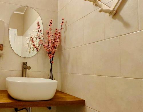 a bathroom with a white sink and a mirror at Ristorante Bellavista con Locanda in Veleso