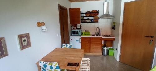 a small kitchen with a wooden table in a room at Apartments Kapus Center in Bled