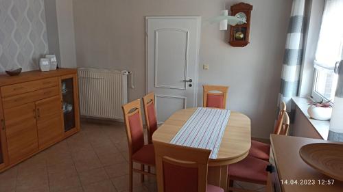 a kitchen with a table and chairs and a dining room at Ferienhaus am Dreieck in Renkenberge