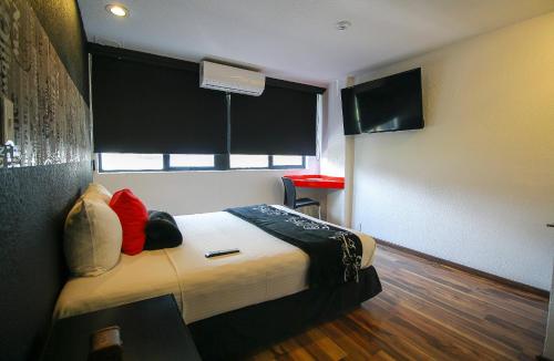a hotel room with a bed and a window at Hotel Black Boutique in Mexico City