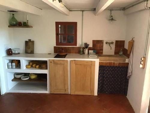 a kitchen with a sink and a counter top at Un cabanon en Provence in Auriol