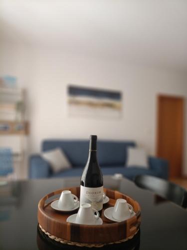 a bottle of wine sitting on top of a table at Stylish 1br in Gaia near Porto, sleeps 4 in Vila Nova de Gaia