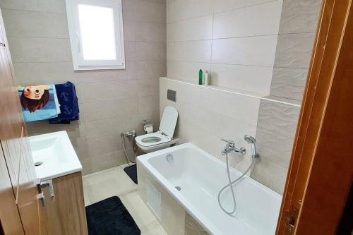 a small bathroom with a toilet and a sink at Villa ilian in Monastir
