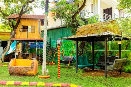 a playground with a swing and a gazebo at Belljem Homes -your own private resort -6 BHK S in Trichūr