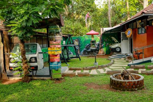 a yard with a car parked next to a house at Belljem Homes -your own private resort -6 BHK S in Trichūr