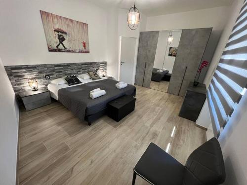 a bedroom with a bed and a living room at Cinque Terre HUB LUXURY HOME IN LA SPEZIA in La Spezia